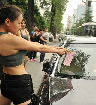 Illustration for article titled Chinese Lara Croft Lookalikes Handing Out Traffic Warnings in Hotpants